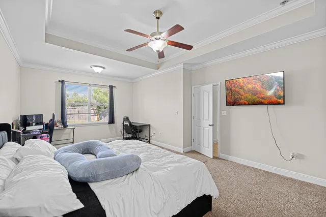 a bedroom with a bed and a painting on the wall