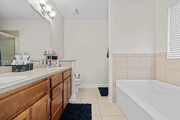 a bathroom with a tub sink and a mirror