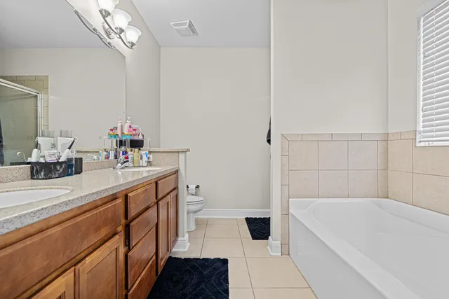 a bathroom with a tub sink and a mirror