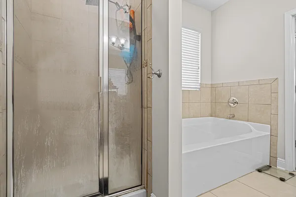a bathroom with a bathtub and shower