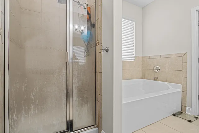 a bathroom with a bathtub and shower