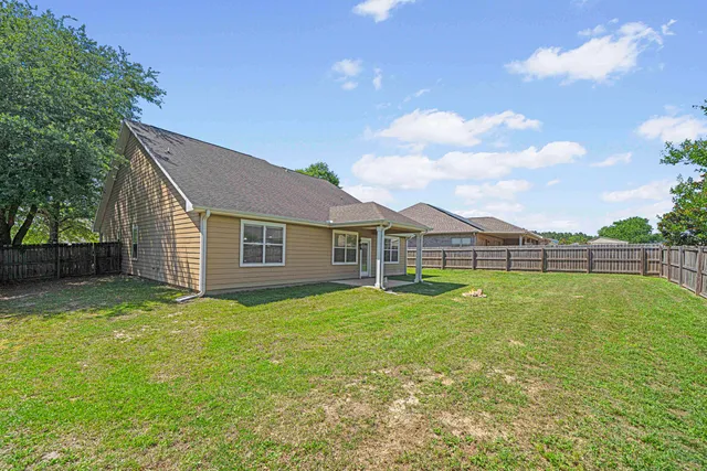 a view of a backyard of the house