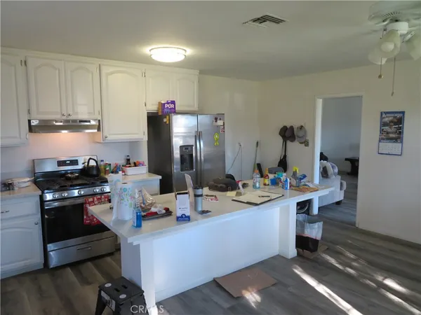 a view of a kitchen with dining table and chairs
