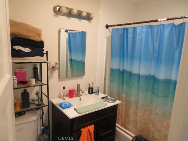 a bathroom with a sink vanity and a mirror