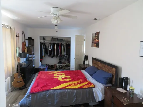 a bed room with a bed mirror and a chandelier