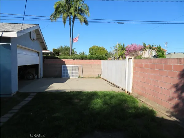 a view of backyard with seating area and green space
