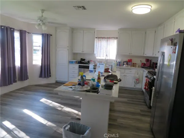 a view of a kitchen with refrigerator and window