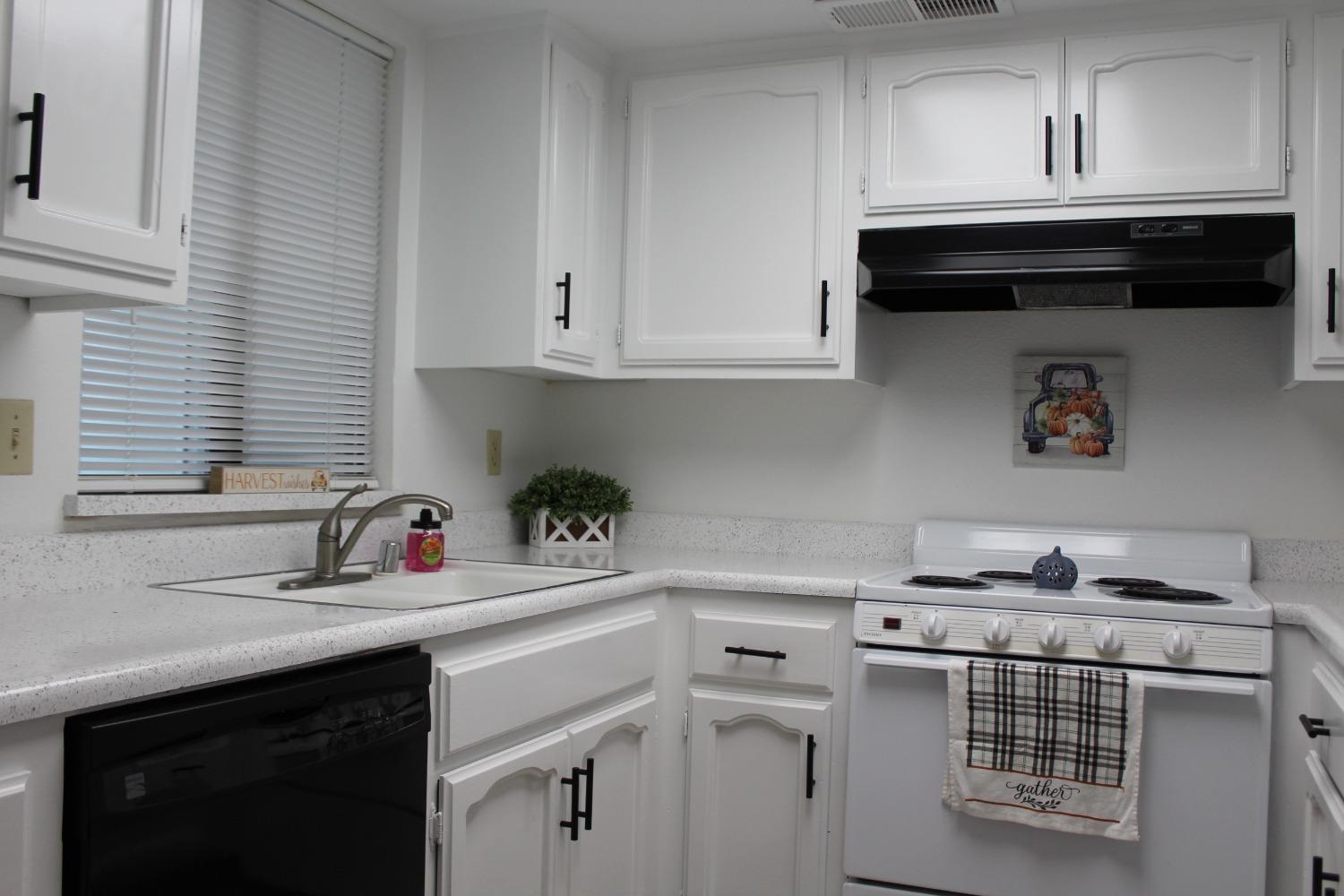13431 South Henderson Road Caruthers, CA 93609 - Photo 6 of 14 a kitchen with a sink cabinets and a stove top oven
