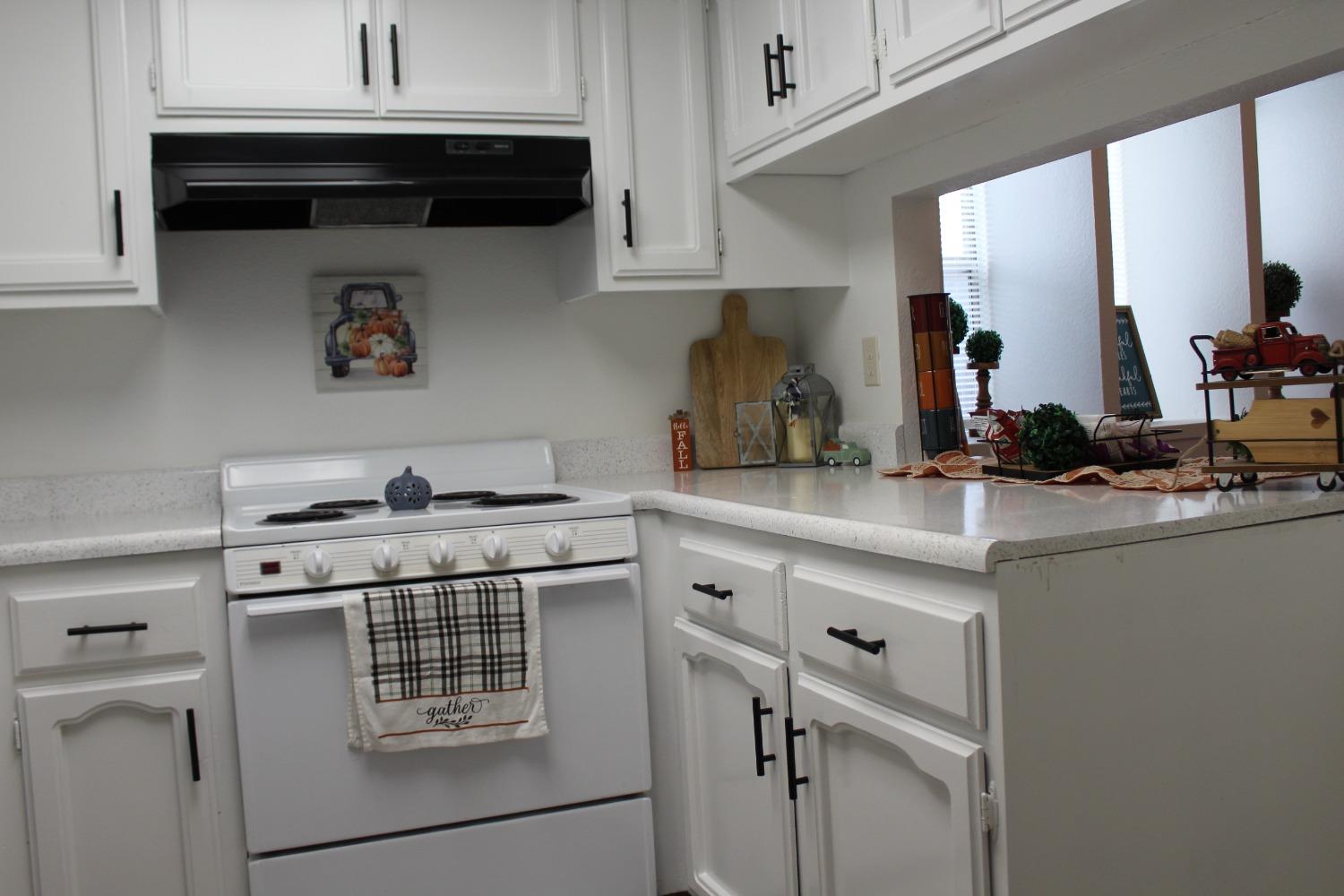 13431 South Henderson Road Caruthers, CA 93609 - Photo 7 of 14 a kitchen with stainless steel appliances a sink stove and cabinets