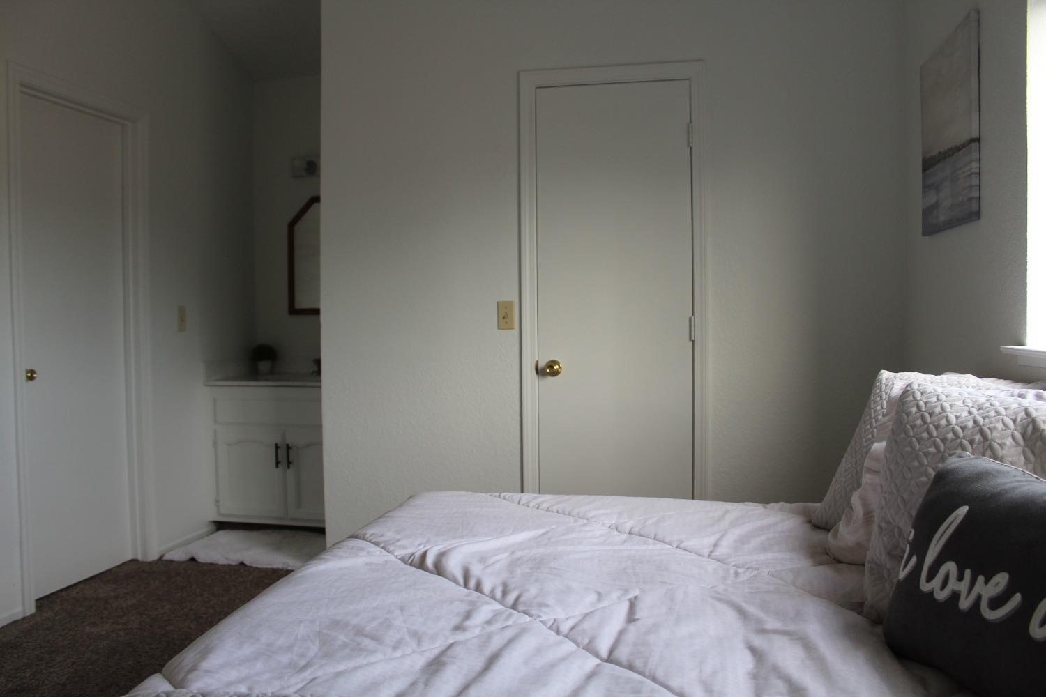 13431 South Henderson Road Caruthers, CA 93609 - Photo 10 of 14 a bedroom with a bed and a couch