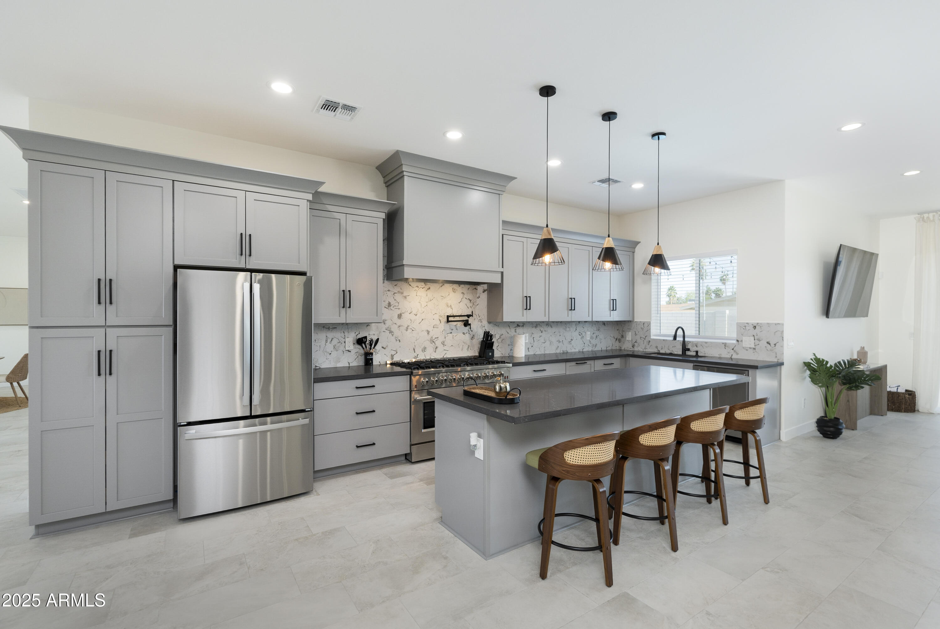 5049 East Shaw Butte Drive Scottsdale, AZ 85254 - Photo 11 of 88 a kitchen with a refrigerator a sink and a stove