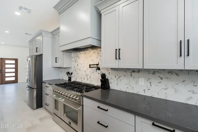 a stove top oven sitting inside of a kitchen