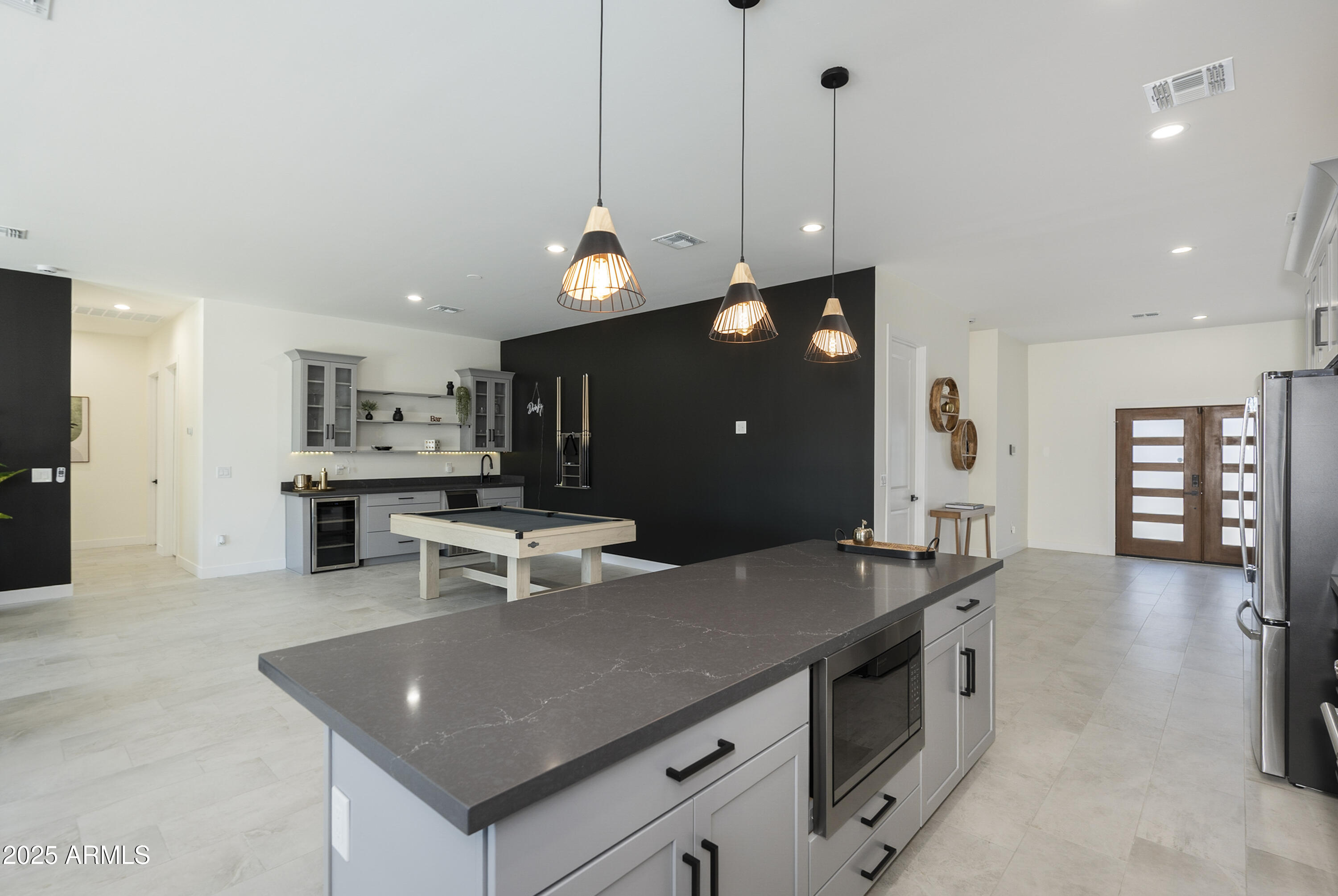 5049 East Shaw Butte Drive Scottsdale, AZ 85254 - Photo 16 of 88 a view of a kitchen counter top space a sink wooden floor and living room view