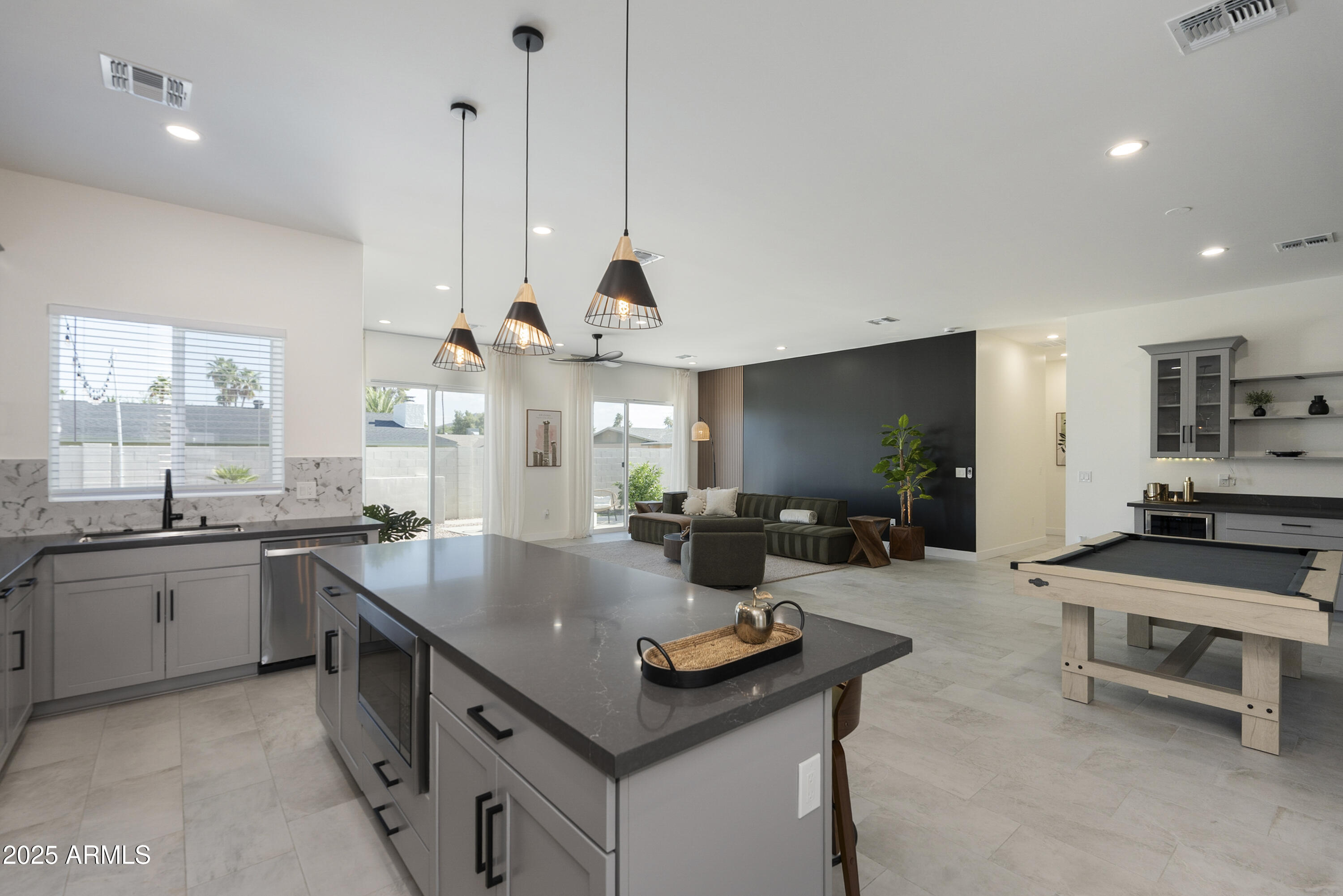 5049 East Shaw Butte Drive Scottsdale, AZ 85254 - Photo 17 of 88 a kitchen with counter space sink stove and living room view