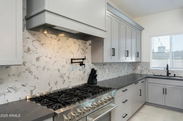 a room with stainless steel appliances kitchen island a table and chairs in it