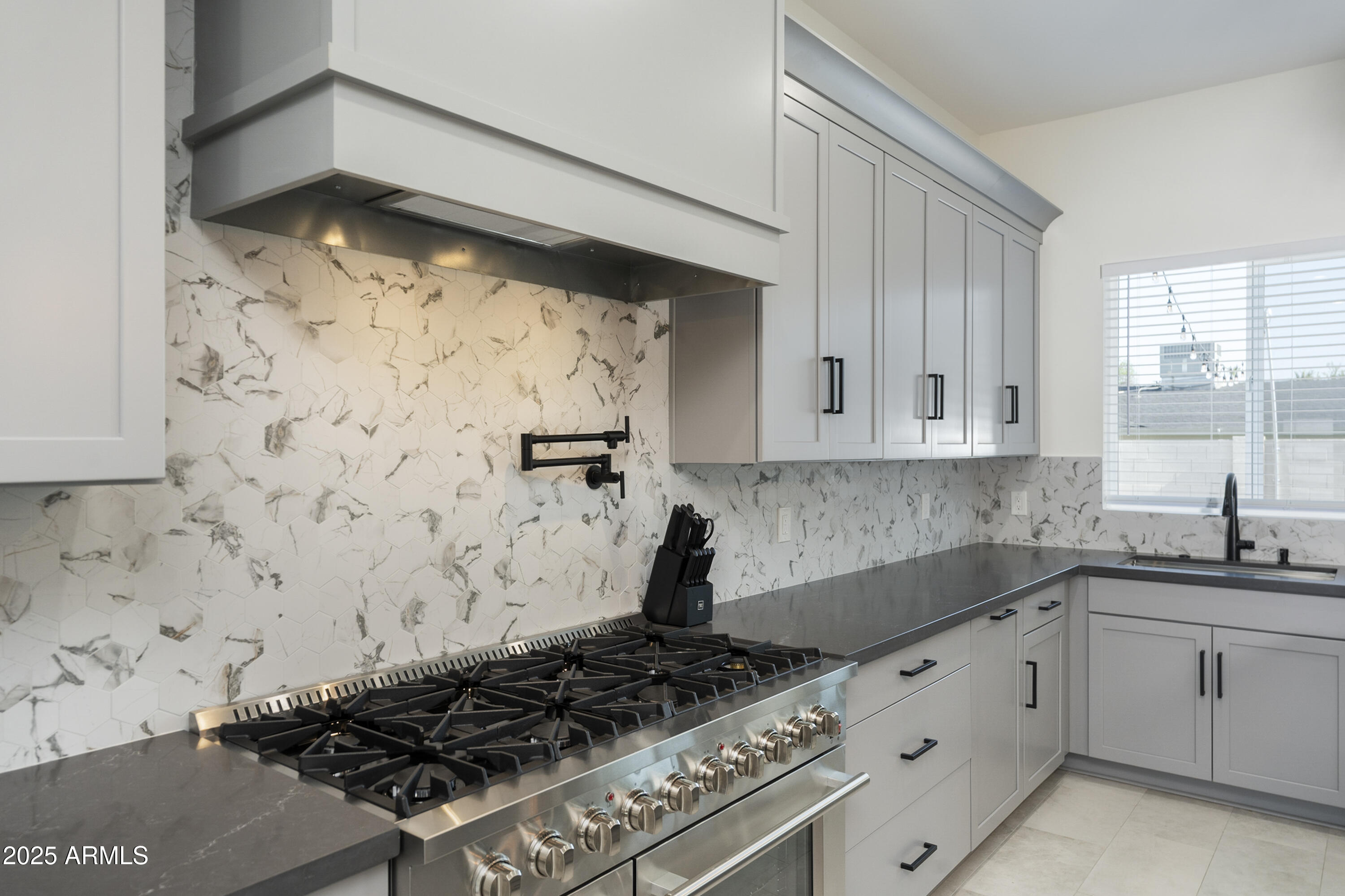 5049 East Shaw Butte Drive Scottsdale, AZ 85254 - Photo 21 of 88 a kitchen with granite countertop a stove sink and cabinets