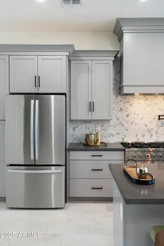 a kitchen with granite countertop cabinets stove and sink