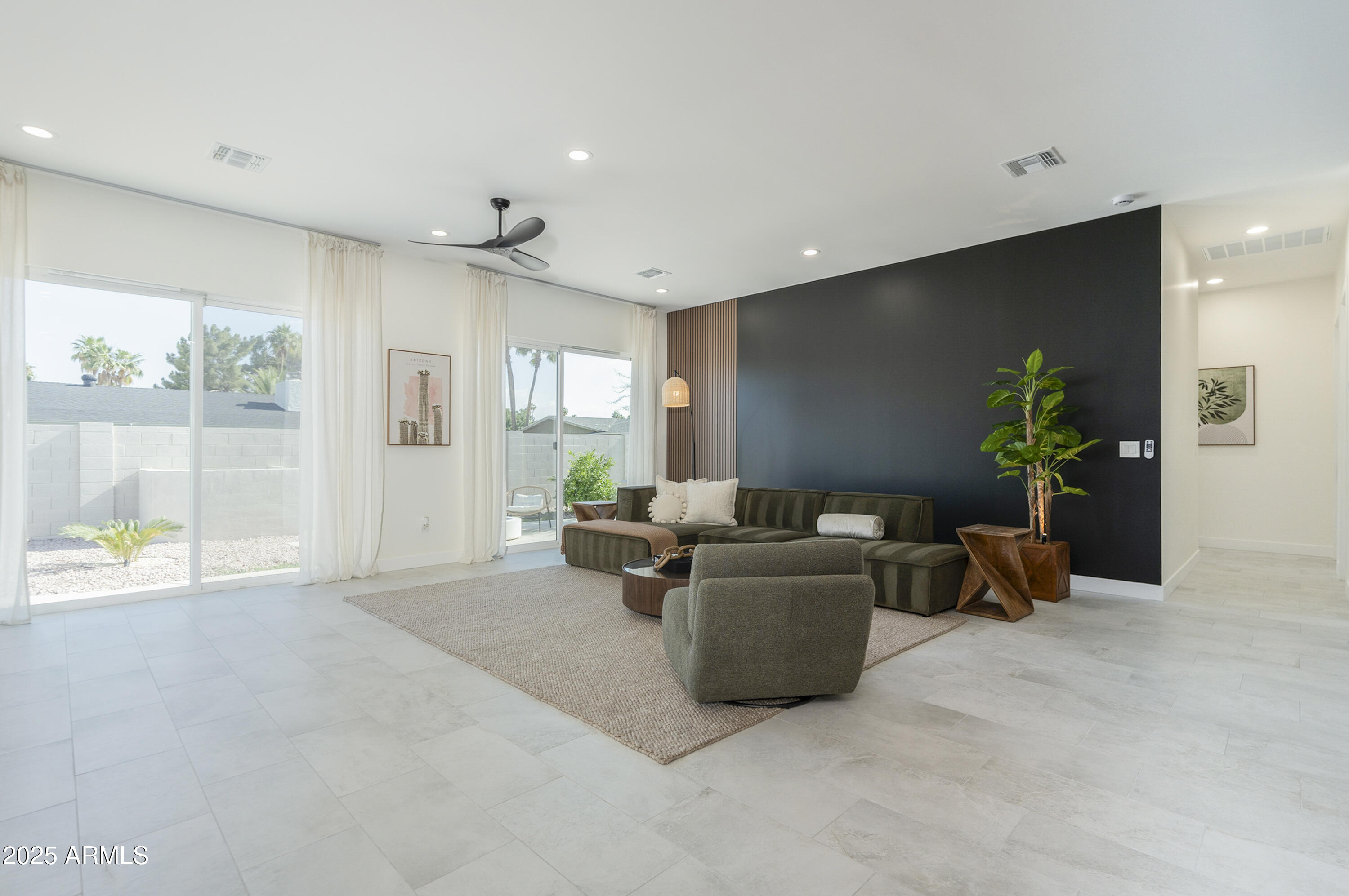 5049 East Shaw Butte Drive Scottsdale, AZ 85254 - Photo 23 of 88 a living room with furniture and a potted plant