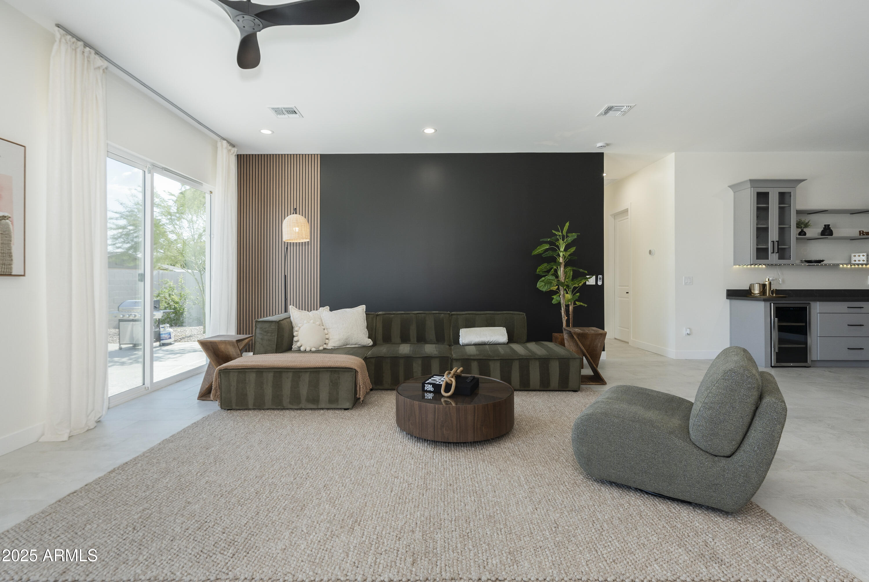 5049 East Shaw Butte Drive Scottsdale, AZ 85254 - Photo 24 of 88 a living room with furniture and a flat screen tv