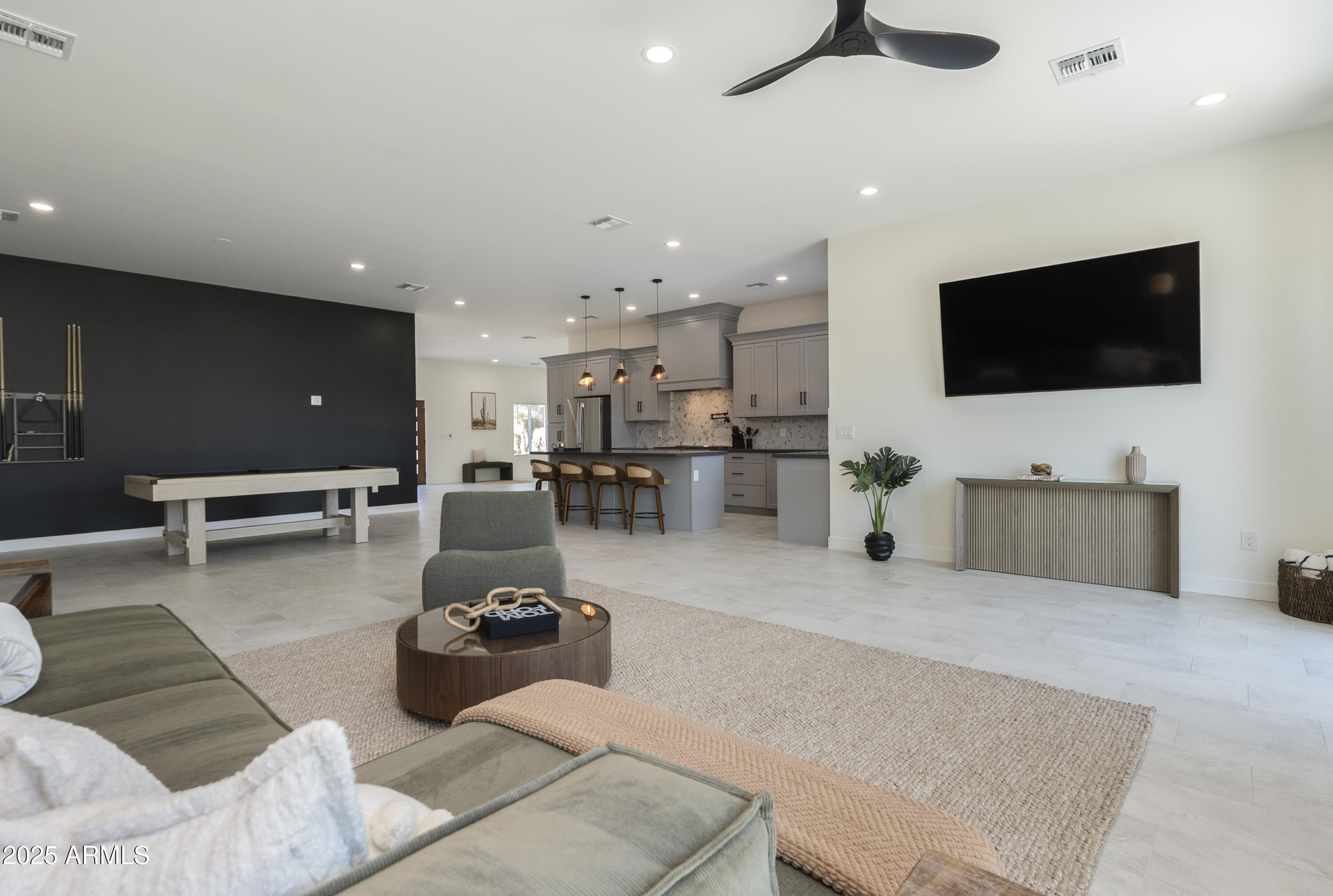 5049 East Shaw Butte Drive Scottsdale, AZ 85254 - Photo 26 of 88 a living room with furniture and a flat screen tv