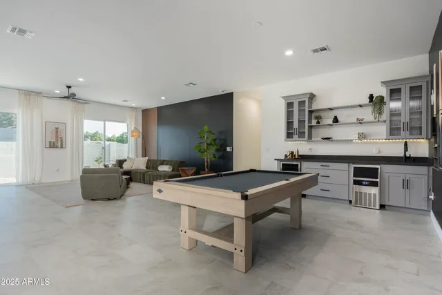a bedroom with a bed and large window