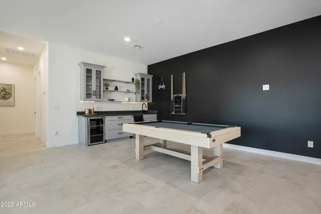 a bedroom with two beds and painting on the wall