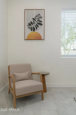 a view of a garden with couches chairs under an umbrella
