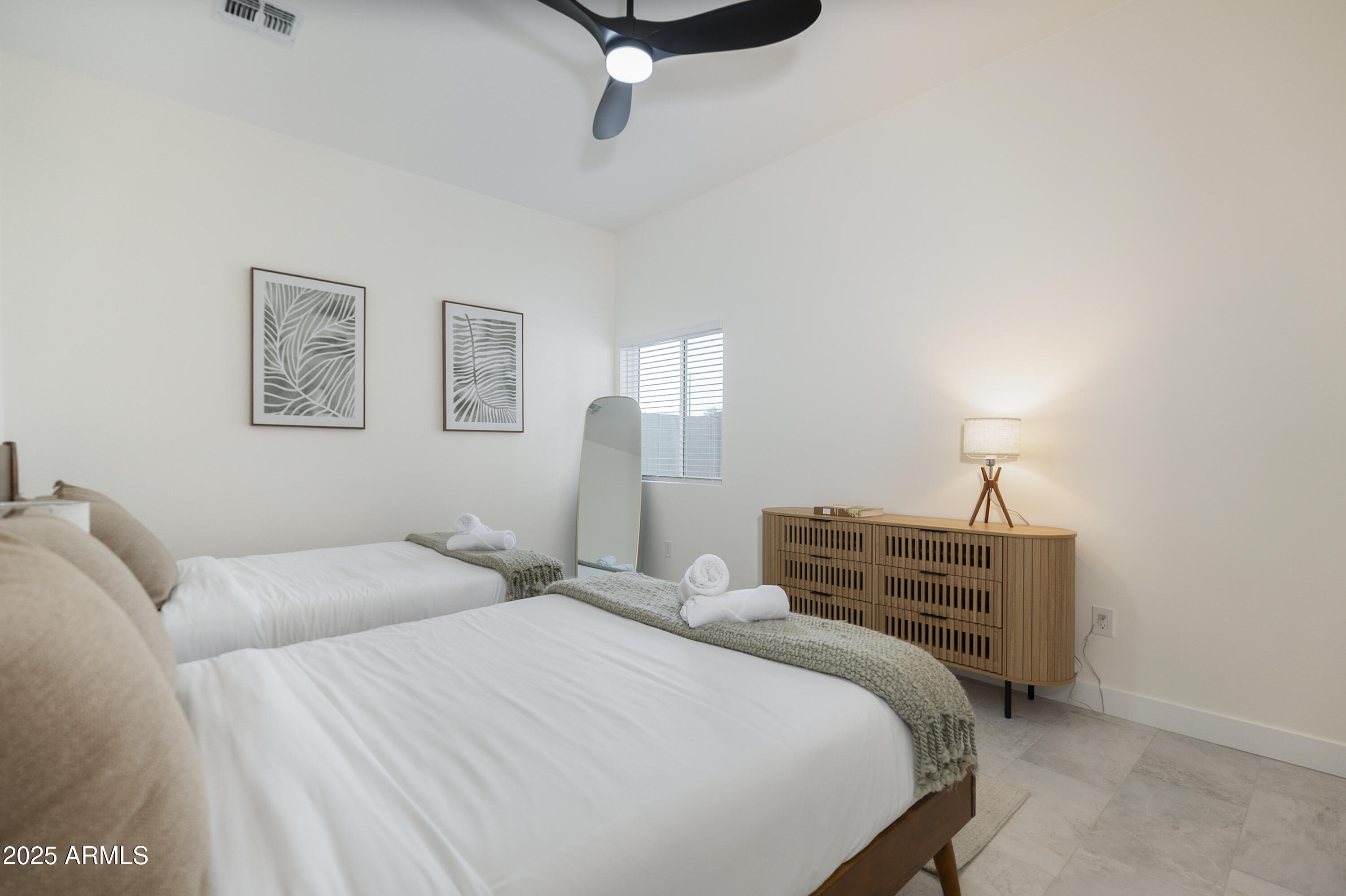 5049 East Shaw Butte Drive Scottsdale, AZ 85254 - Photo 56 of 88 a bedroom with a bed and a lamp