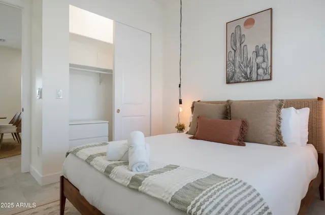 a kitchen with stainless steel appliances granite countertop a sink a stove a dining table and chairs