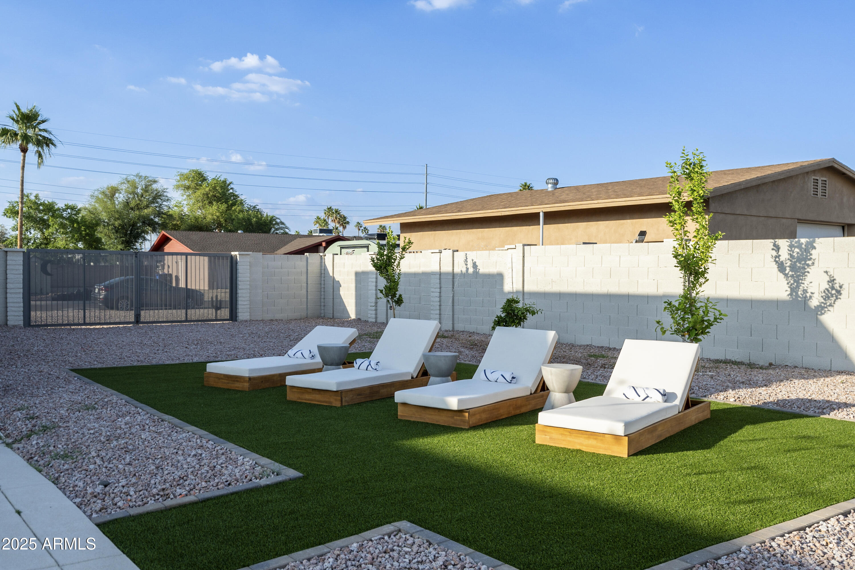 5049 East Shaw Butte Drive Scottsdale, AZ 85254 - Photo 72 of 88 a view of a garden with couches chairs under an umbrella