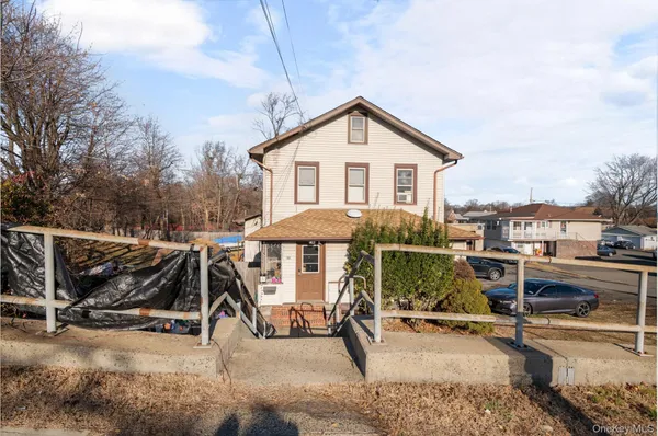 a view of a house with backyard sitting area and roof