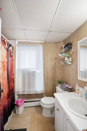 a bedroom with a bed and ceiling fan