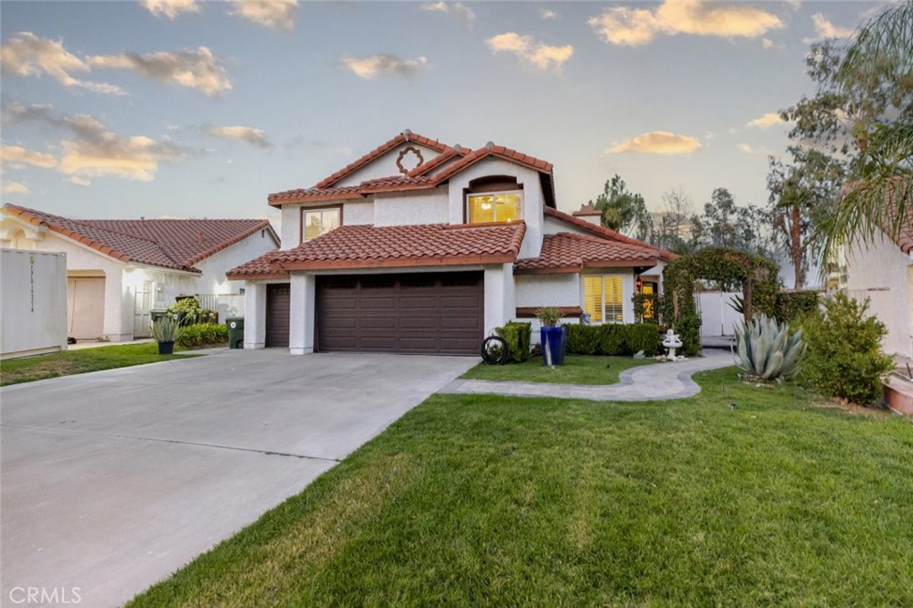 25010 Foxtail Court Stevenson Ranch, CA 91381 - Photo 16 of 64 a front view of a house with a yard and garage