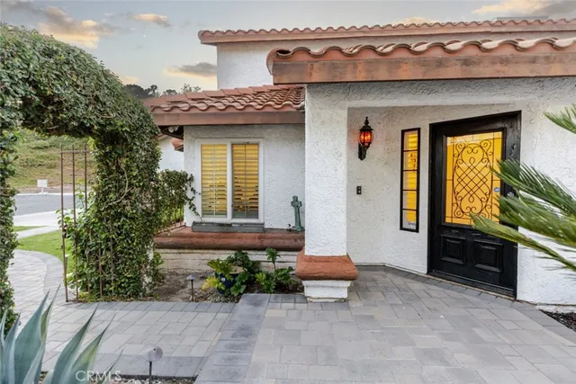 a view of living room filled with furniture and a chandelier