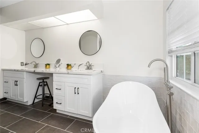 a view of a patio with couches and a fire pit and wooden fence