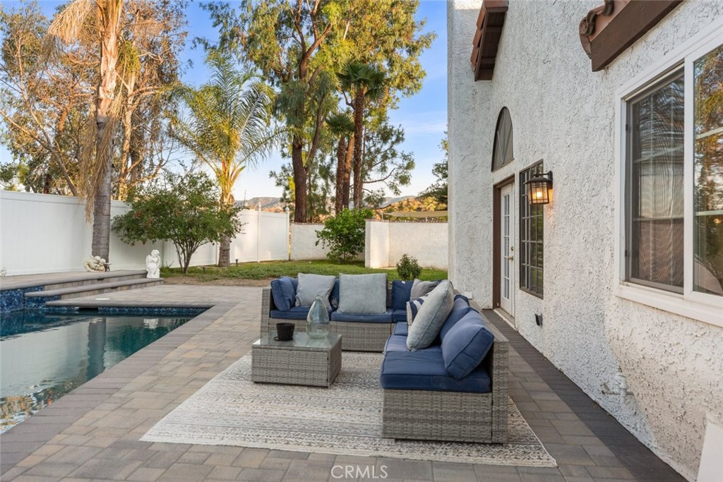 25010 Foxtail Court Stevenson Ranch, CA 91381 - Photo 54 of 64 a view of a patio with couches and a fire pit and wooden fence