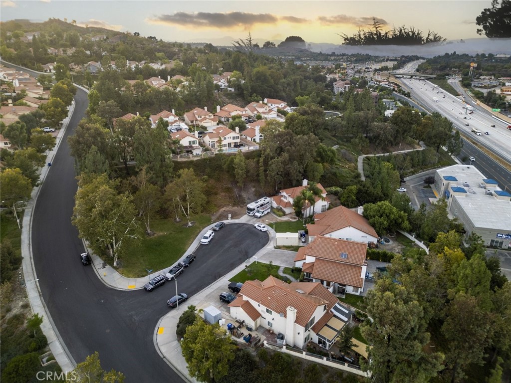 25010 Foxtail Court Stevenson Ranch, CA 91381 - Photo 63 of 64 an aerial view of a house with a swimming pool a yard and lake view