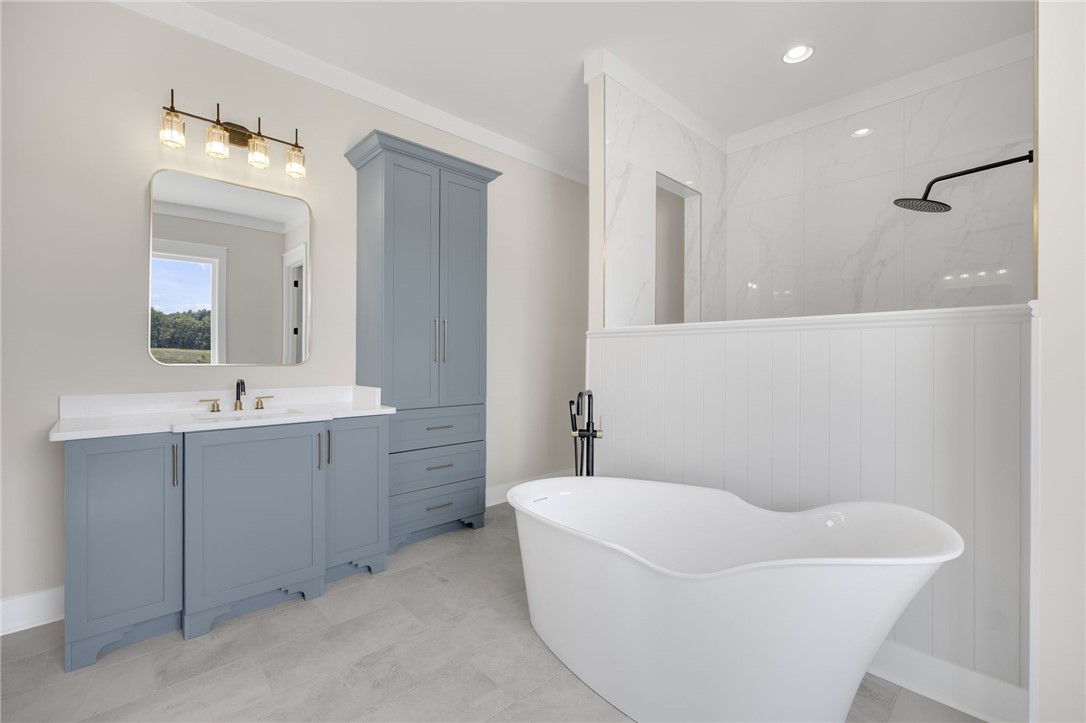 384 Jim Smith Road Pendleton, SC 29670 - Photo 17 of 48 Elegant bathroom design highlights a freestanding soaking tub alongside clean tile flooring.