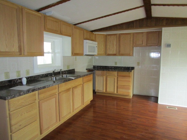 730 Mt Tabor Road Staunton, VA 24401 - Photo 5 of 13 a kitchen with stainless steel appliances granite countertop a sink a stove cabinets and wooden floor