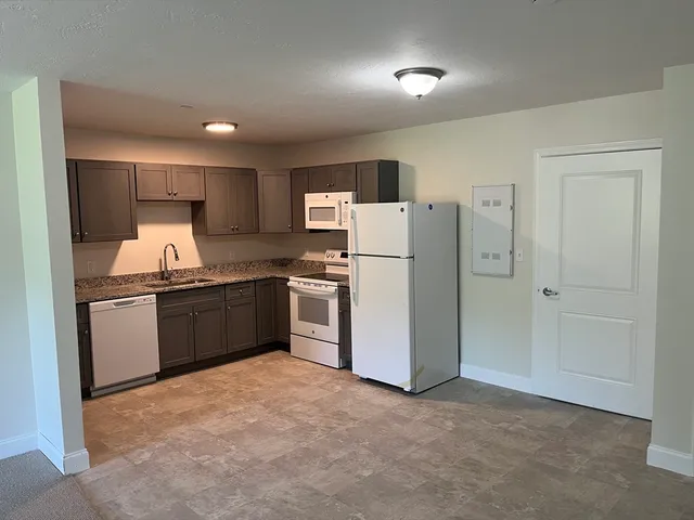 a kitchen with refrigerator and cabinets