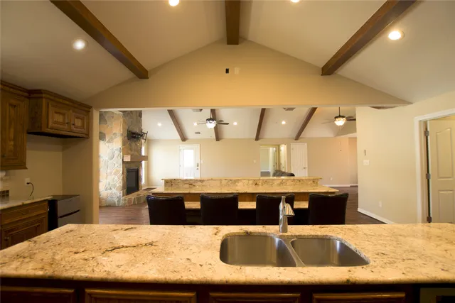 a kitchen with kitchen island sink and refrigerator