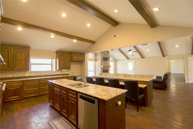 a kitchen with a sink and living room
