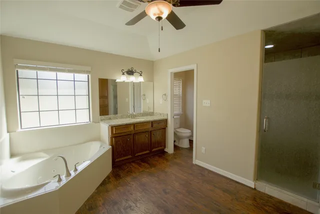 a bathroom with a tub sink and mirror