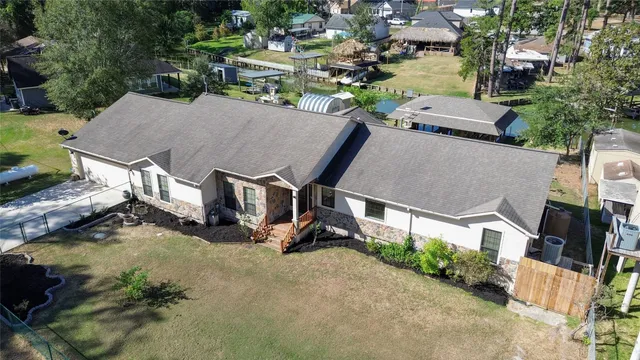 an aerial view of a house with swimming pool outdoor seating and yard