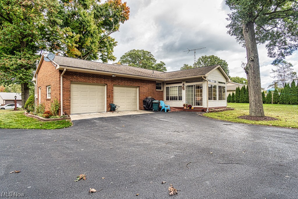 2 car attached garage, paved driveway, all seasons room