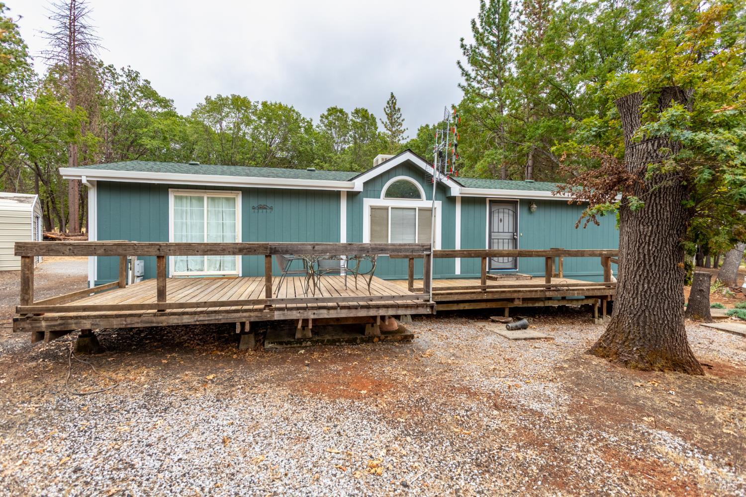29282 Laurel Tree Lane Shingletown, CA 96088 - Photo 1 of 1 a view of a house with a backyard and a wooden deck