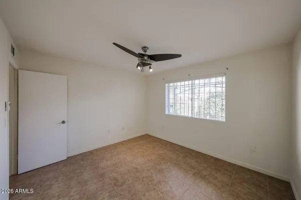 a view of a livingroom with a ceiling fan and window