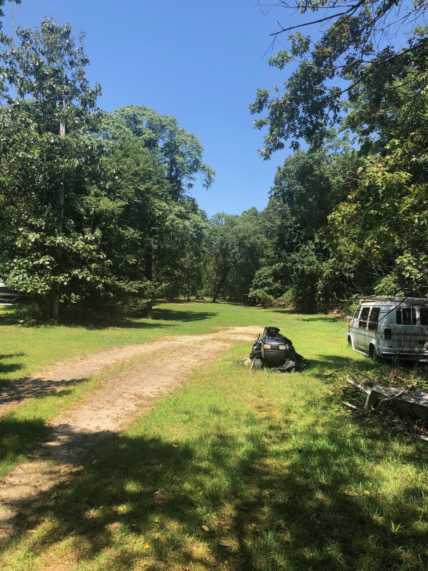 260 Kent Road Howell, NJ 07731 - Photo 2 of 4 a view of a swimming pool with a yard and large trees