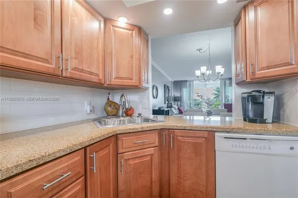 a kitchen with a refrigerator and a sink