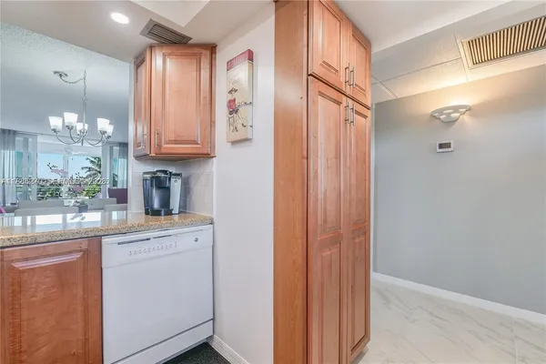 a kitchen with a refrigerator and table chair